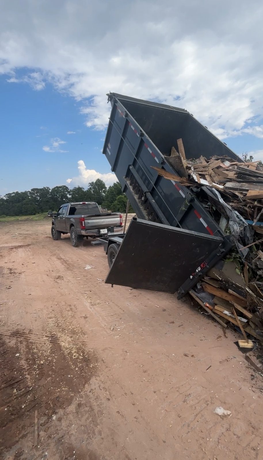 Dump trailer unloading demolition debris